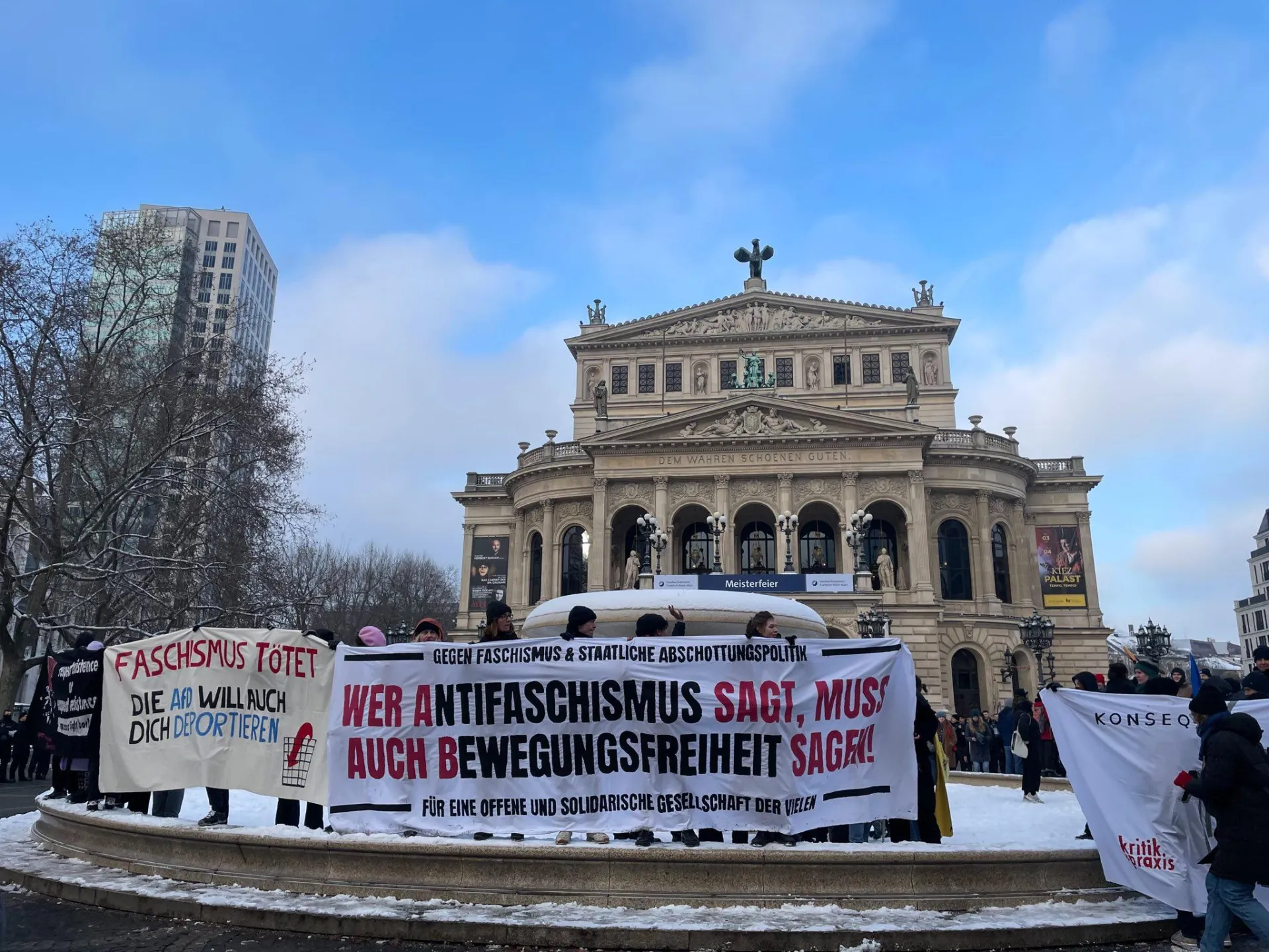 Menschen mit bannern vor historischem Gebäude